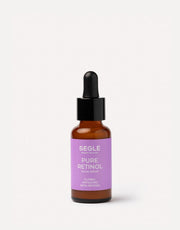 Serúm facial antiarrugas con retinol en frasco de vidrio ámbar con pipeta.